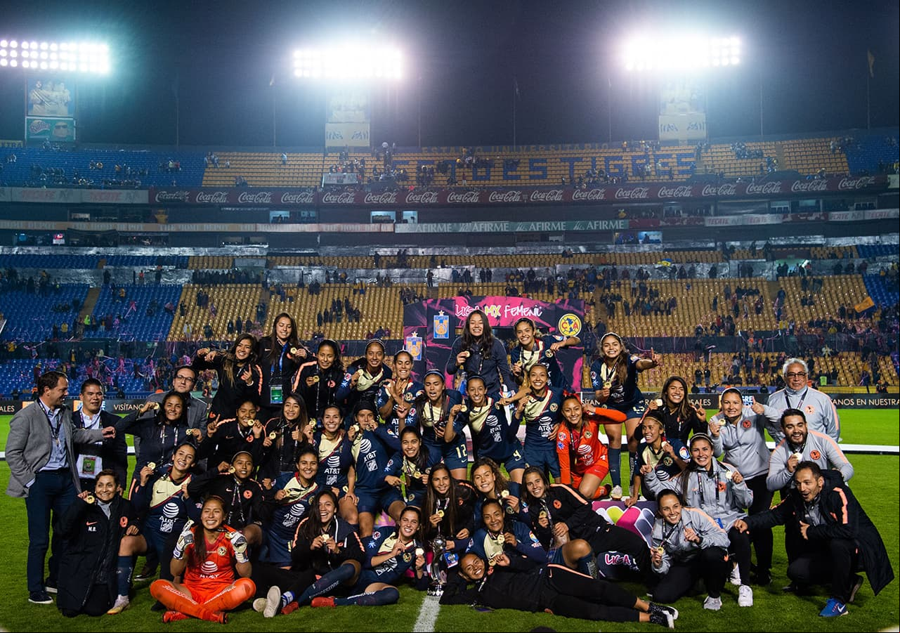 Foto para el recuerdo de las jugadoras del América celebrando la conquista de la Liga MX Femenil en el Estadio Universitario de Monterrey.