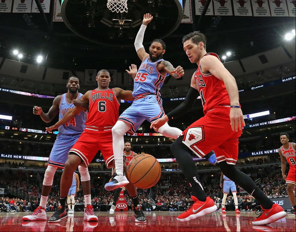 CHICAGO, ILLINOIS - MARCH 03: DeAndre' Bembry #95 of the Atlanta Hawks looses control of the ball between Cristiano Felicio #6 and Ryan Arcidiacono #51 of the Chicago Bulls at the United Center on March 03, 2019 in Chicago, Illinois. The Hawks defeated the Bulls 123-118. NOTE TO :  expressly acknowledges and agrees that, by ing and or using this photograph,  is consenting to the  and conditions of the Getty Images License Agreement. (Photo by Jonathan Daniel/Getty Images)