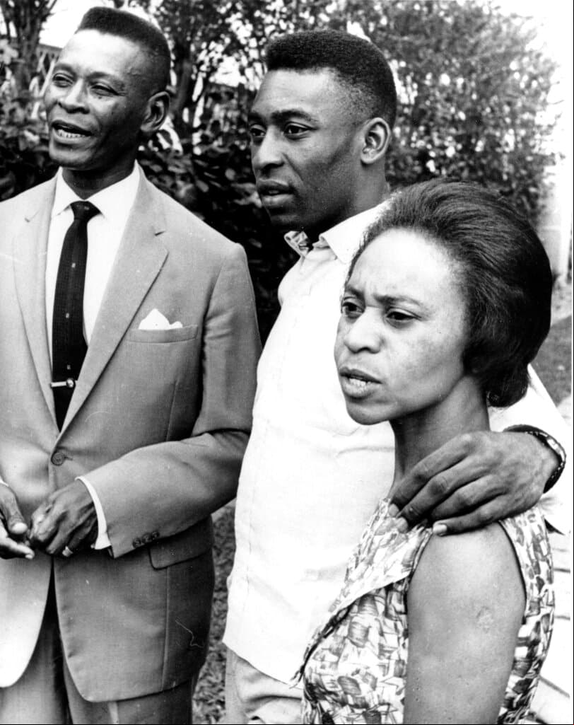 La estrella del fútbol brasileño Pelé, al centro, aparece con su madre, Celeste, y su padre, Dondinho Nascimento, en marzo de 1965.