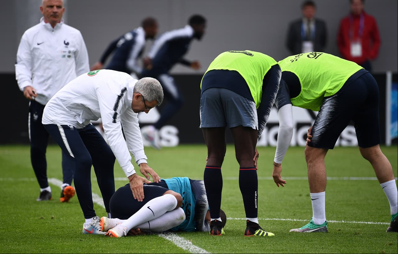 's forward Kylian Mbappe (C) reacts after getting injured during a training session at the Glebovets stadium in Istra, on June 12, 2018, ahead of Russia 2018 World Cup football tournament. (Photo by FRANCK FIFE / AFP) (Photo credit should read FRANCK FIFE/AFP/Getty Images)
