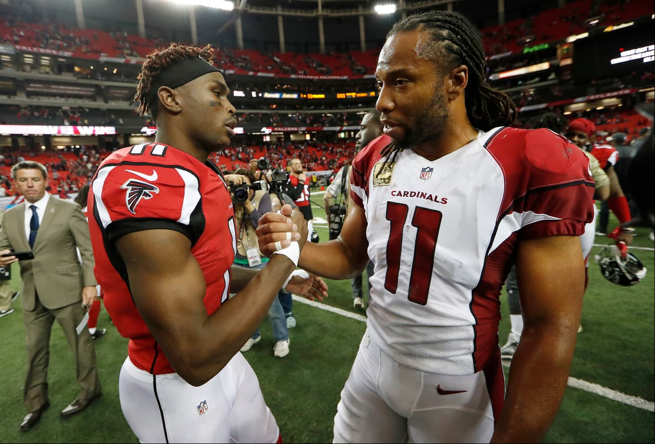 Atlanta Falcons wide receiver Julio Jones (11) speaks to Arizona Cardinals wide receiver Larry Fitzgerald (11) after an NFL football game, Sunday, Nov. 27, 2016, in Atlanta. The Falcons won 38-19. (AP Photo/John Bazemore)