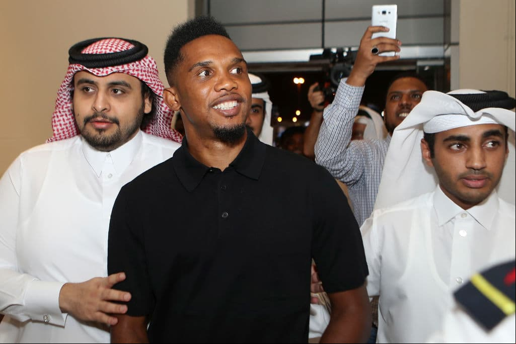 Cameroonian forward Samuel Eto'o arrives to attend a press conference after g a one year contract to play for Qatar Sports Club football team next to the club's president Sheikh Jassim bin Hamad bin Nasser al-Thani (L), in Doha on August 14, 2018. - Veteran Cameroon star Samuel Eto'o has signed for Qatar league side, Qatar Sports Club, it was announced August 14, just days after he ended a brief stay at Turkish side Konyaspor. (Photo by KARIM JAAFAR / AFP) (Photo credit should read KARIM JAAFAR/AFP via Getty Images)