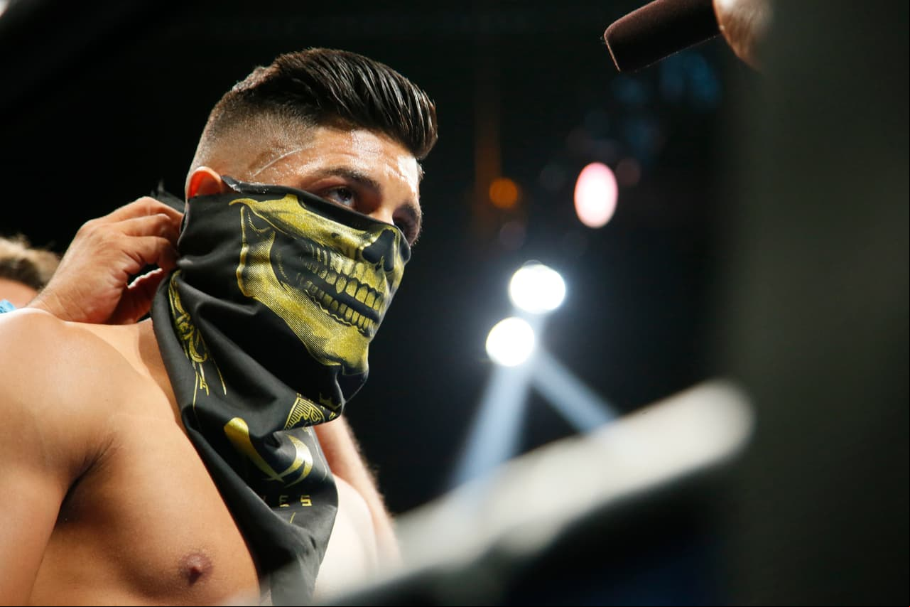 Abner Mares wears a skeleton bandana around his face before fighting against Leo Santa Cruz in their WBC diamond featherweight and WBA featherweight championship boxing bout, Saturday, Aug. 29, 2015, in Los Angeles. (AP Photo/Danny Moloshok)