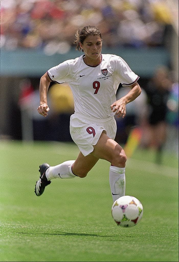 Mia Hamm de los Estados Unidos, para muchos la mejor de todos los tiempos, corre con el esférico mostrando su técnica eante el equipo de China en el Rose Bowl el 10 de julio de 1999 en Pasadena, California. Esa vez, el Team USA venció 5-4 a las chinas en un juego que se fue a la prórroga.