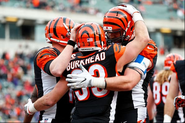 CINCINNATI, OH - JANUARY 1: Rex Burkhead #33 is congratulated by Andy Dalton #14 and Jake Fisher #74, all of the Cincinnati Bengals, after scoring a touchdown during the fourth quarter of the game against the Baltimore Ravens at Paul Brown Stadium on January 1, 2017 in Cincinnati, Ohio. Cincinnati defeated Baltimore 27-10. (Photo by Michael Hickey/Getty Images)