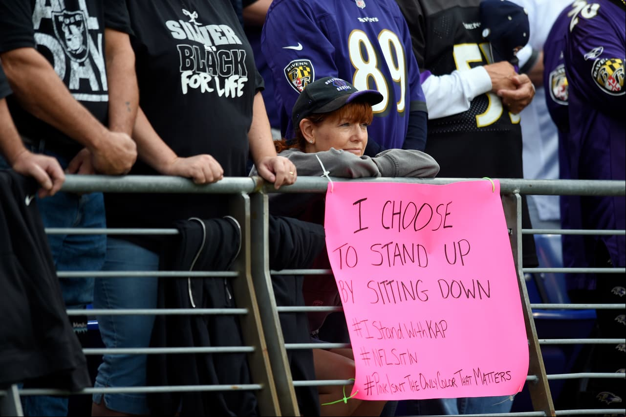 A Baltimore Ravens fan displays a sign in  of San Francisco 49ers quarterback Colin Kaepernick before an NFL football game between the Baltimore Ravens and the Oakland Raiders, Sunday, Oct. 2, 2016, in Baltimore. (AP Photo/Gail Burton)