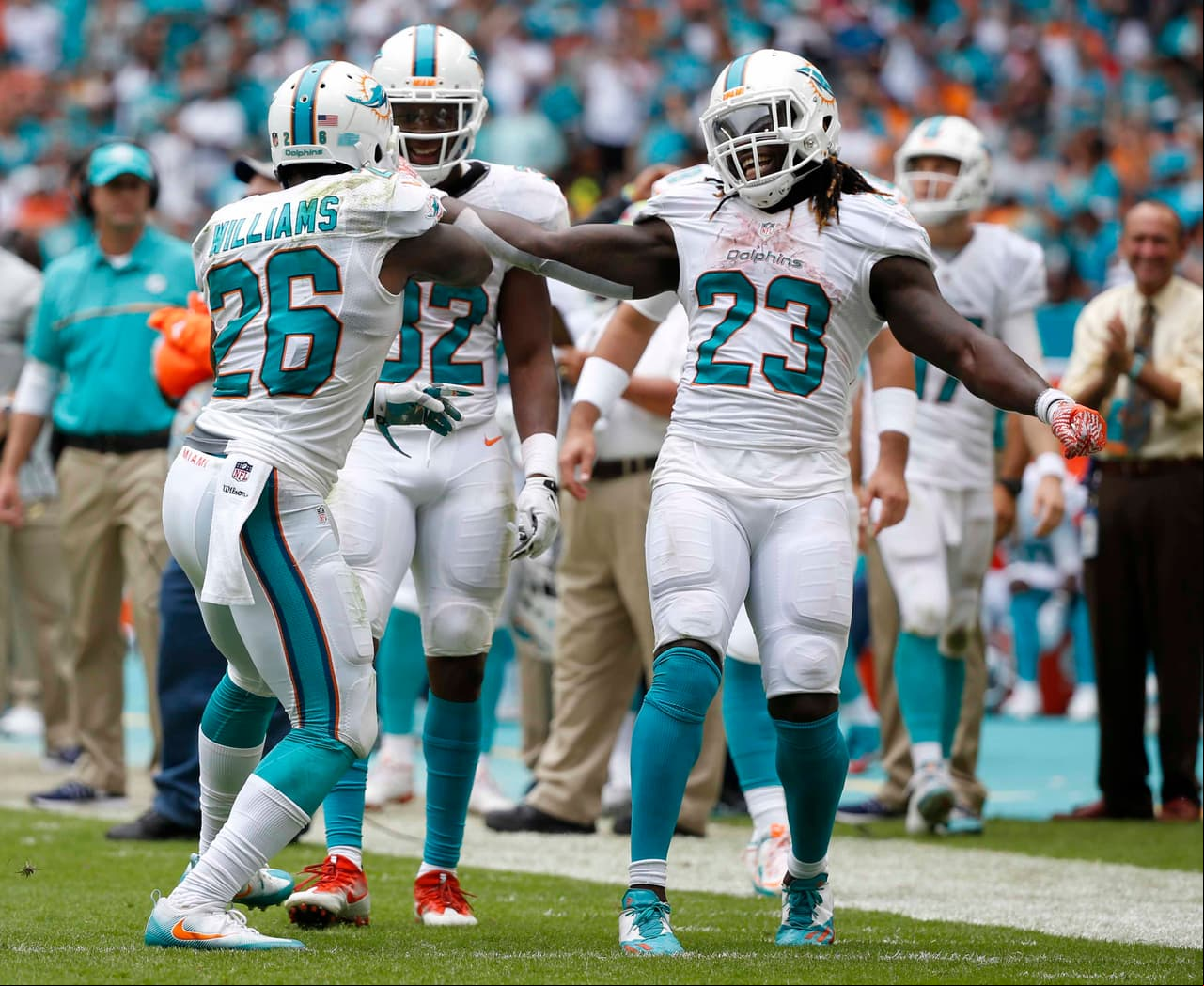 Miami Dolphins running backs Kenyan Drake (32) and Jay Ajayi (23) congratulate Damien Williams (26), after Williams scored a touchdown against the Cleveland Browns, Sunday, Sept. 25, 2016, in Miami Gardens, Fla. (AP Photo/Wilfredo Lee)