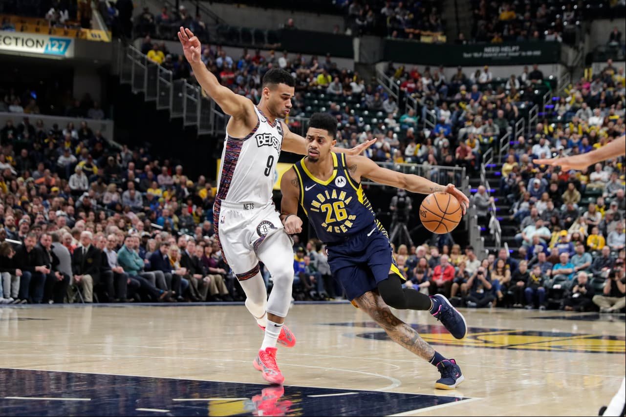 Jeremy Lamb cubre la pelota pese a la marca de Chris Chiozza de los Brooklyn Nets.
