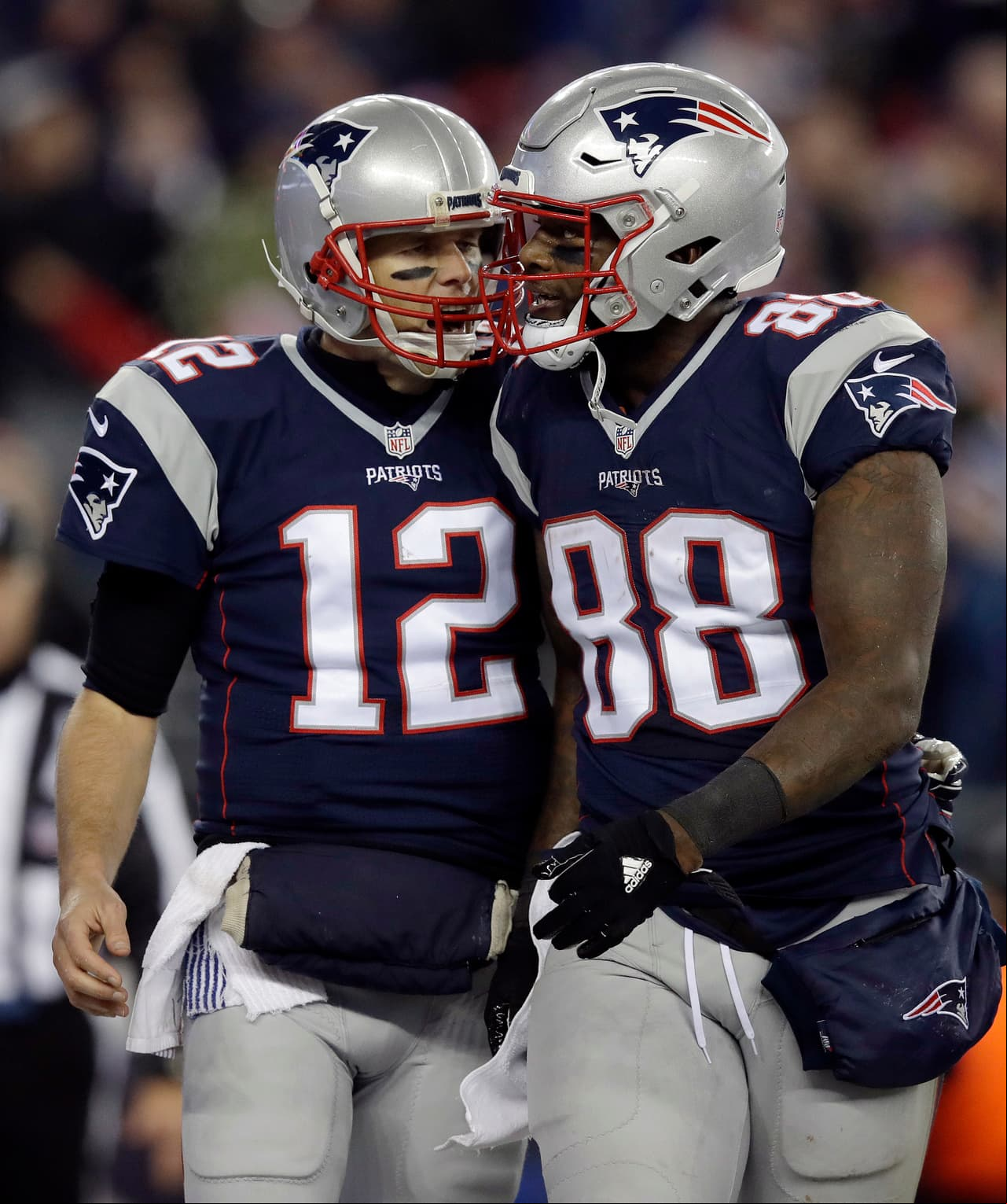 New England Patriots quarterback Tom Brady (12) celebrates his touchdown  to tight end Martellus Bennett (88) during the second half of an NFL football game against the Baltimore Ravens, Monday, Dec. 12, 2016, in Foxborough, Mass. (AP Photo/Charles Krupa)