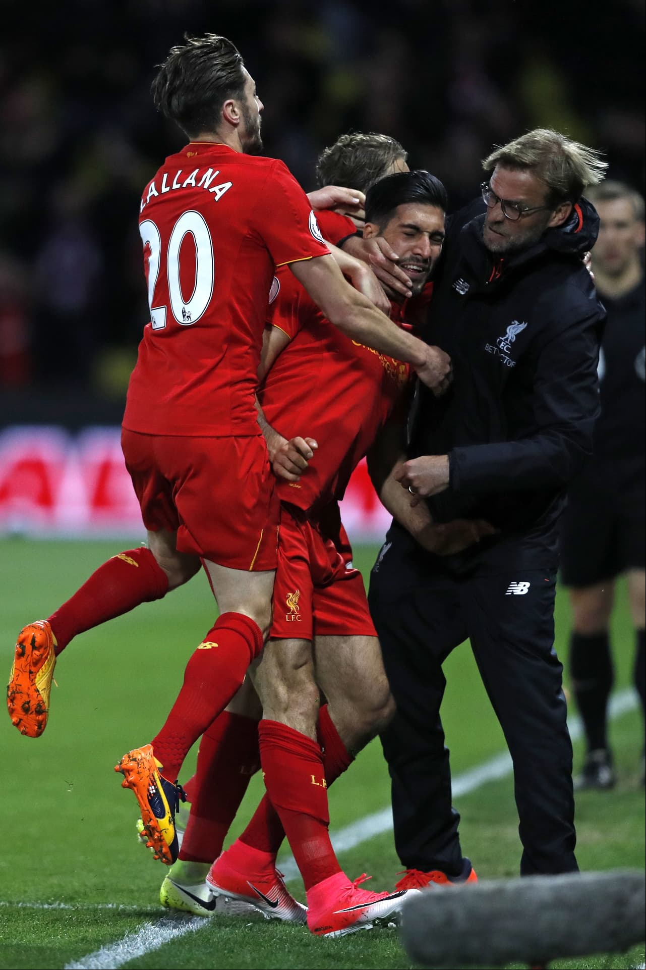 Liverpool's German midfielder Emre Can (C) celebrates with Liverpool's English midfielder Adam Lallana (L) and Liverpool's German manager Jurgen Klopp after scoring the opening goal of the English Premier League football match between Watford and Liverpool at Vicarage Road Stadium in Watford, north of London on May 1, 2017. / AFP PHOTO / Adrian DENNIS / RESTRICTED TO EDITORIAL USE. No use with unauthorized audio, video, data, fixture lists, club/league logos or 'live' services. Online in-match use limited to 75 images, no video emulation. No use in betting, games or single club/league/player publications. / (Photo credit should read ADRIAN DENNIS/AFP/Getty Images)