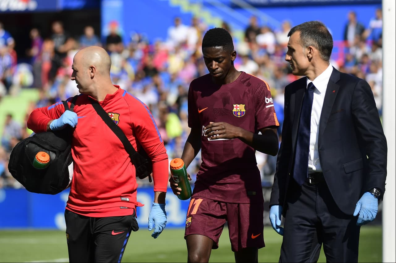 Barcelona's forward from  Ousmane Dembele (C) walks with the team's doctor during the Spanish league football match Getafe CF vs FC Barcelona at the Col. Alfonso Perez stadium in Getafe on September 16, 2017. / AFP PHOTO / PIERRE-PHILIPPE MARCOU (Photo credit should read PIERRE-PHILIPPE MARCOU/AFP/Getty Images)