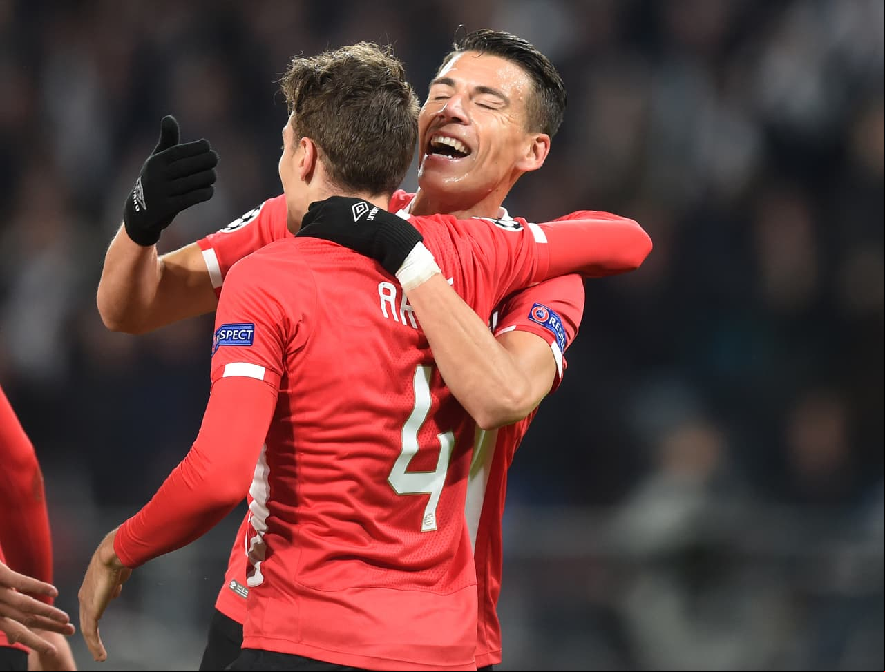 PSV Eindhoven's Colombian defender Santiago Arias celebrates with PSV Eindhoven's Mexican defender Hector Moreno (back) after scoring a goal during the UEFA Champions League group D football match between PSV Eindhoven and Bayern Munich at the Philips Stadium in Eindhoven on November 1, 2016. / AFP / CHRISTOF STACHE (Photo credit should read CHRISTOF STACHE/AFP/Getty Images)